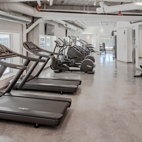 fitness center Large fitness center with cardio and weight lifting equipment.